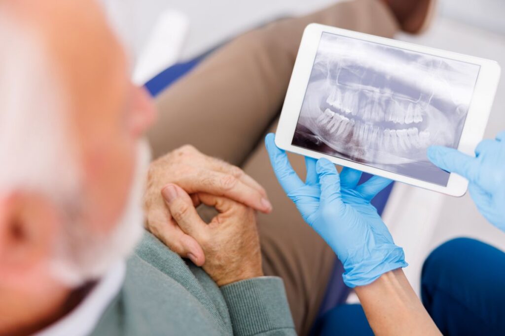 Dentist discussing dental implant costs and treatment options with a patient